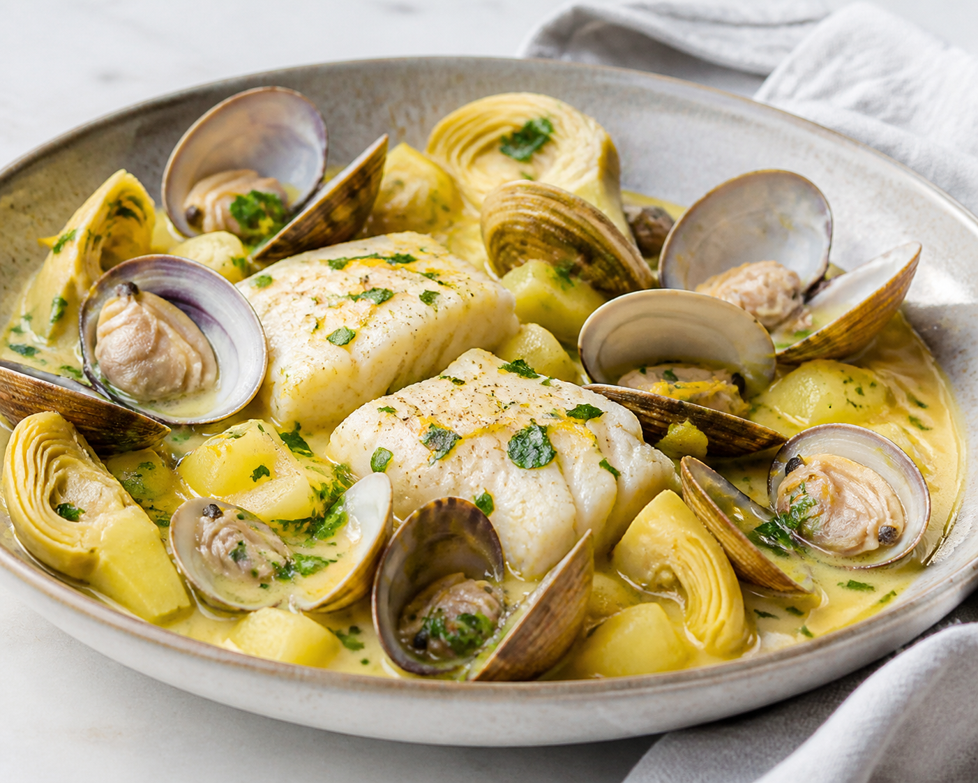 Cod, Clam and Artichoke Skillet with Saffron Potato Cream and Lemon