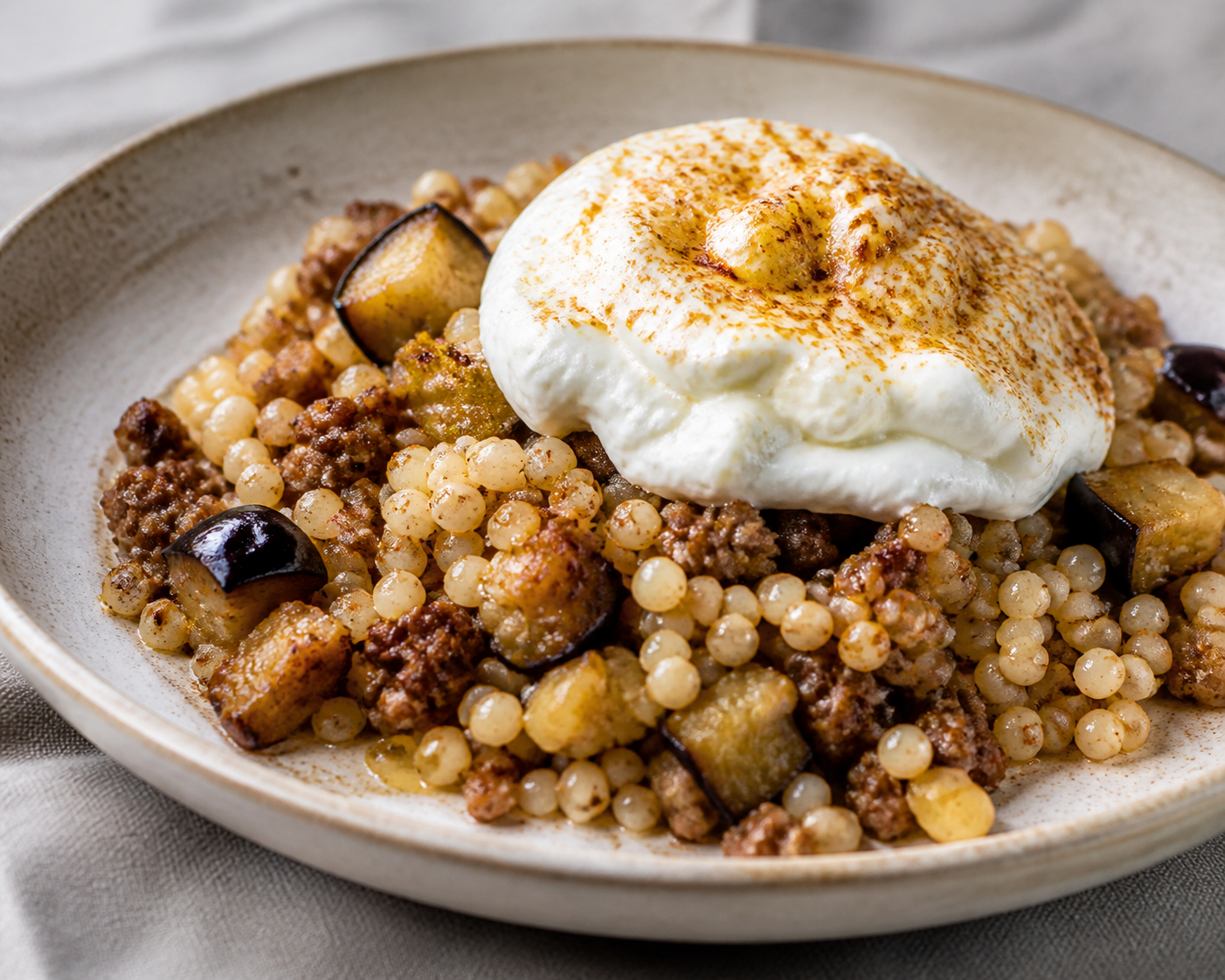 Family Pearl Couscous Bake with Cumin Beef, Roasted Eggplant and Cheesy Yogurt Cloud