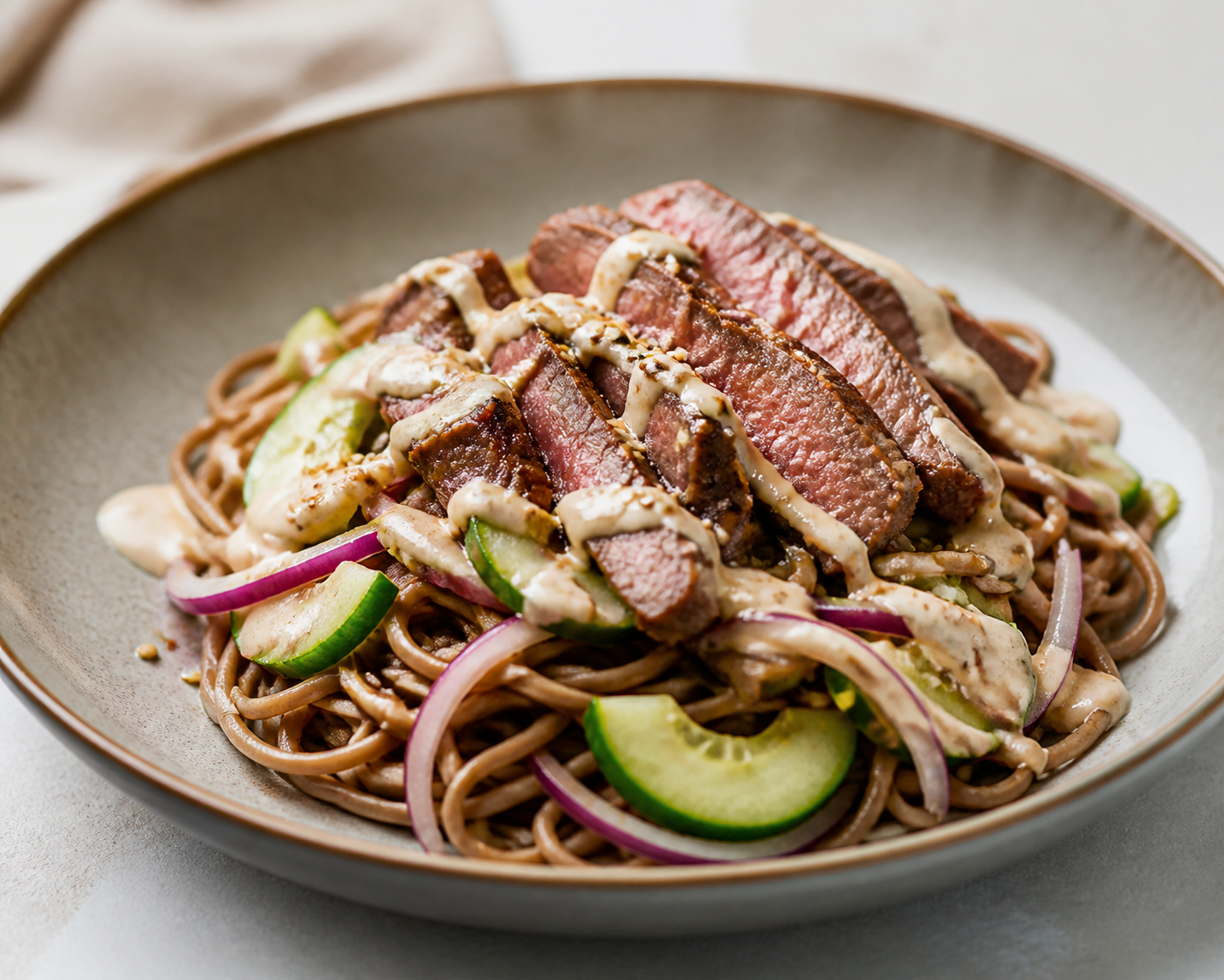 Express soba noodles with sesame beef, warm cucumber and quick tahini-lime cream