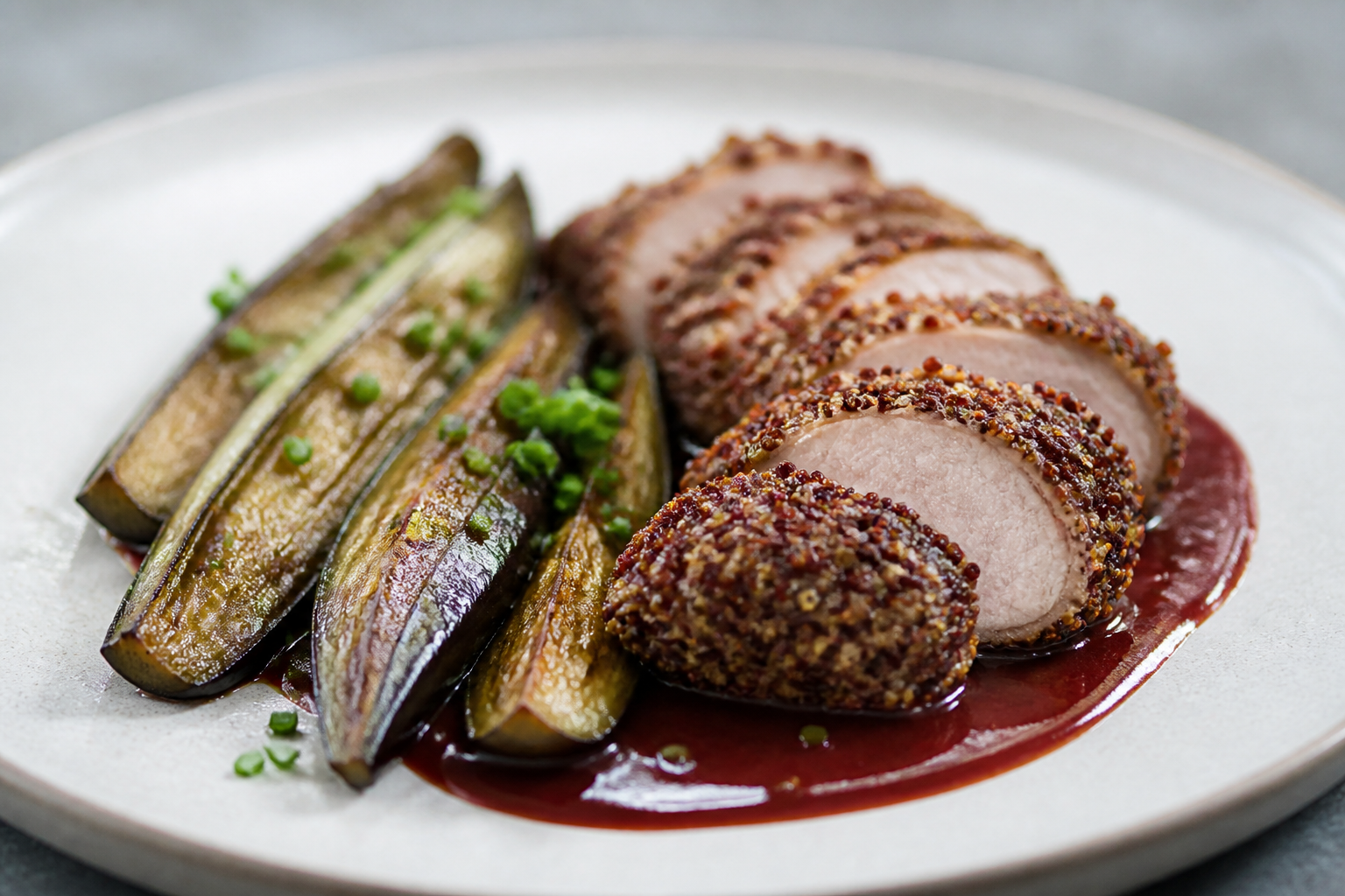 Pork Loin with Red Quinoa Crust, Plum Ginger Sauce, and Roasted Eggplant with Chives