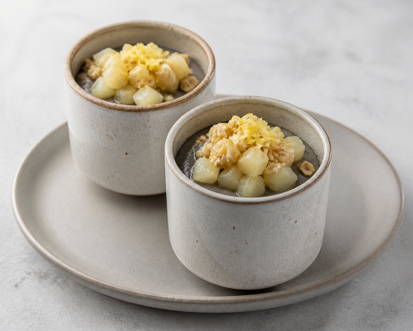Vasitos tibios de crema de sésamo negro con peras al jengibre y crumble de avena salada