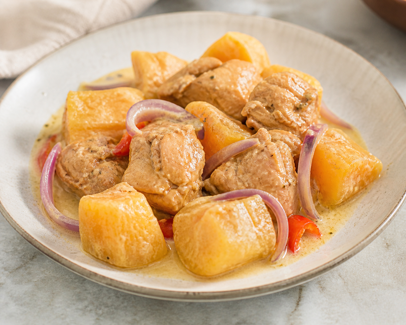 Coconut-Braised Chicken with Golden Yuca and Peppers