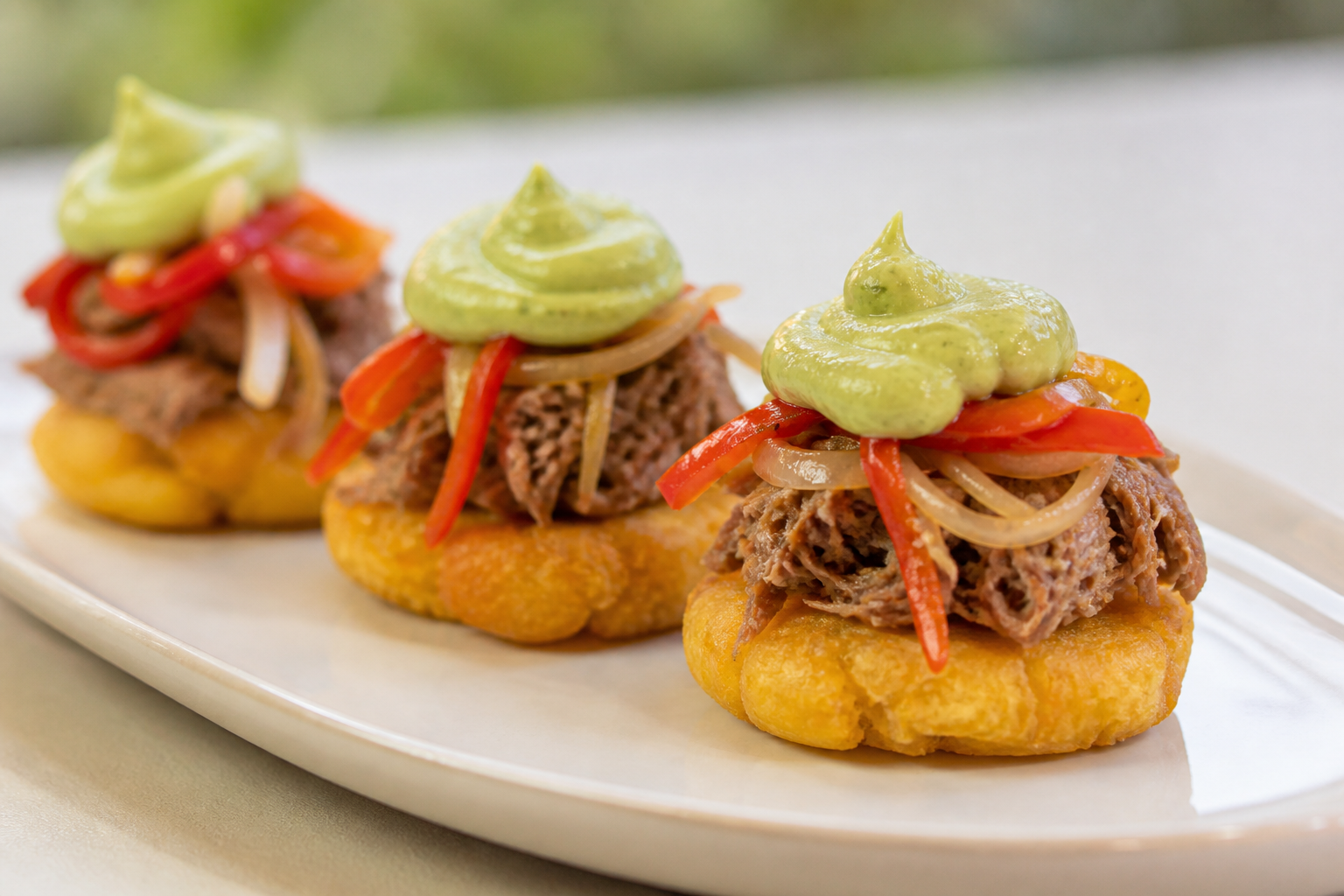 Andean Potato and Corn Bites with Mild Coffee-Shredded Beef and Avocado Cream