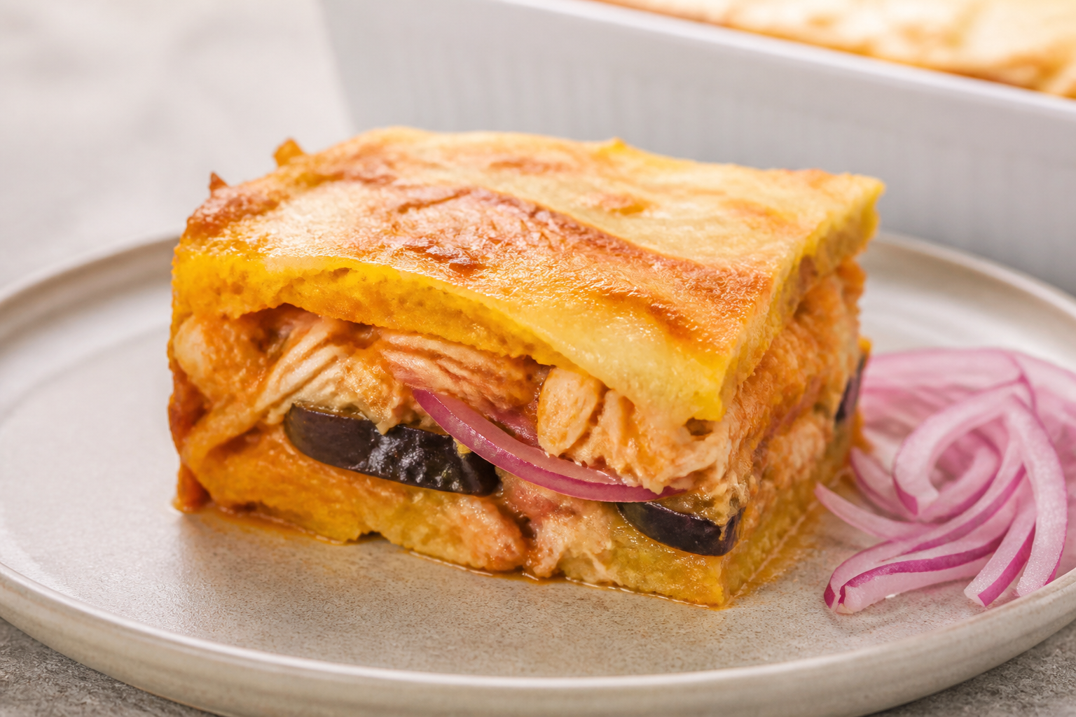 Pastelón Dominicano de Plátano Maduro con Bacalao Guisado, Berenjena y Queso Suave