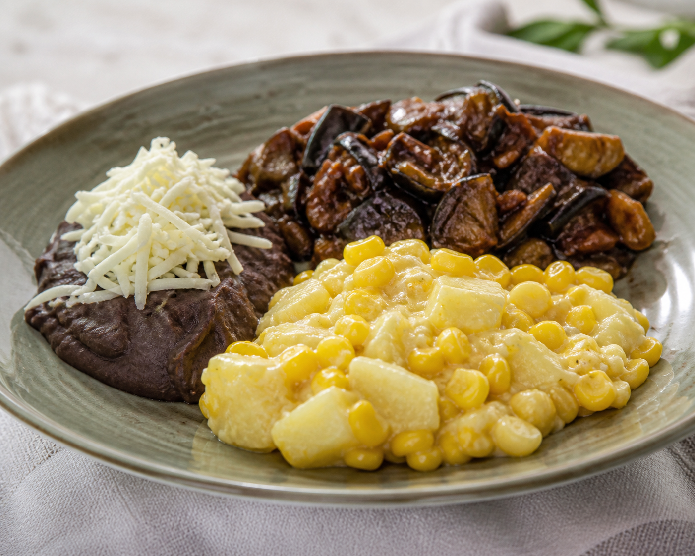 Ocumo and Corn Cazuelitas with Eggplant Asado Negro, Creamy Black Beans, and Llanero Cheese