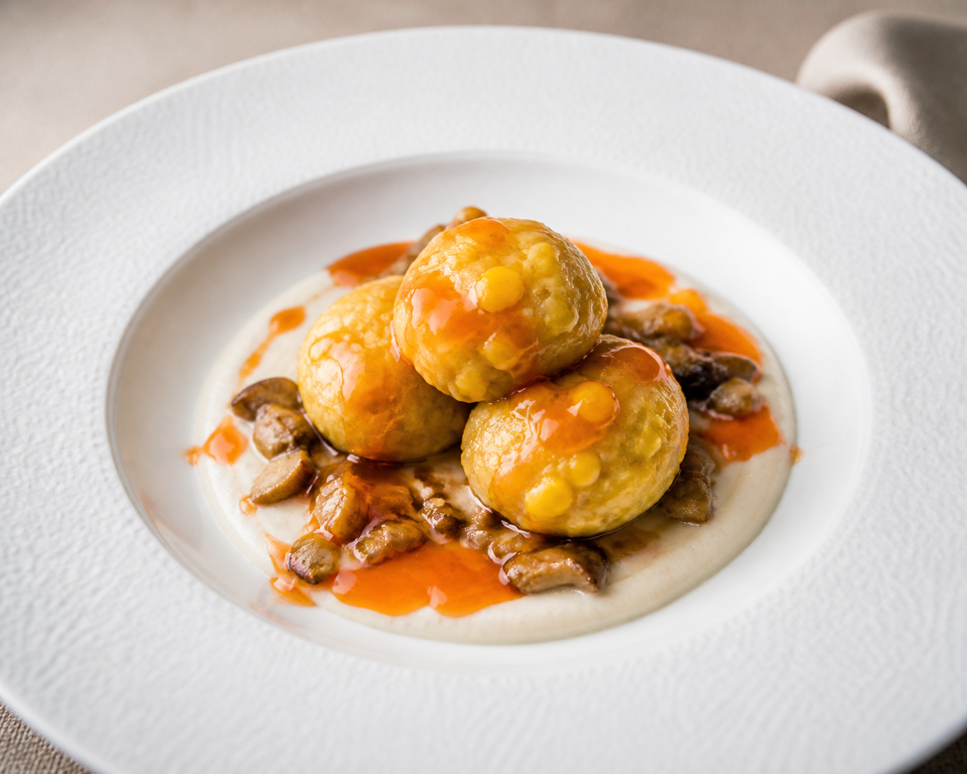Green Plantain and Sweet Corn Dumplings with Mushroom Perico, Guayanés Cheese Cream and Sweet Pepper Citrus Syrup