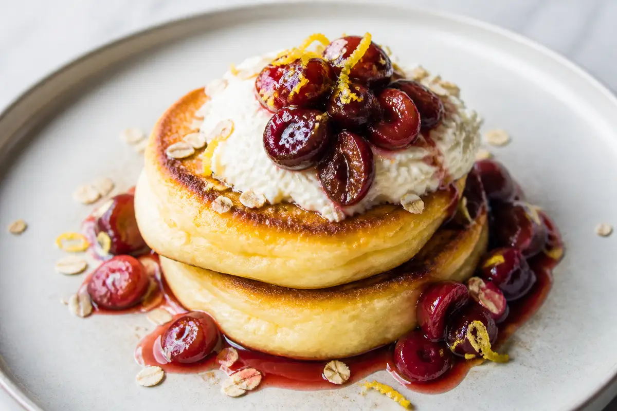 Lemon Oat Soufflé Pancakes with Maple Sautéed Cherries and Whipped Ricotta