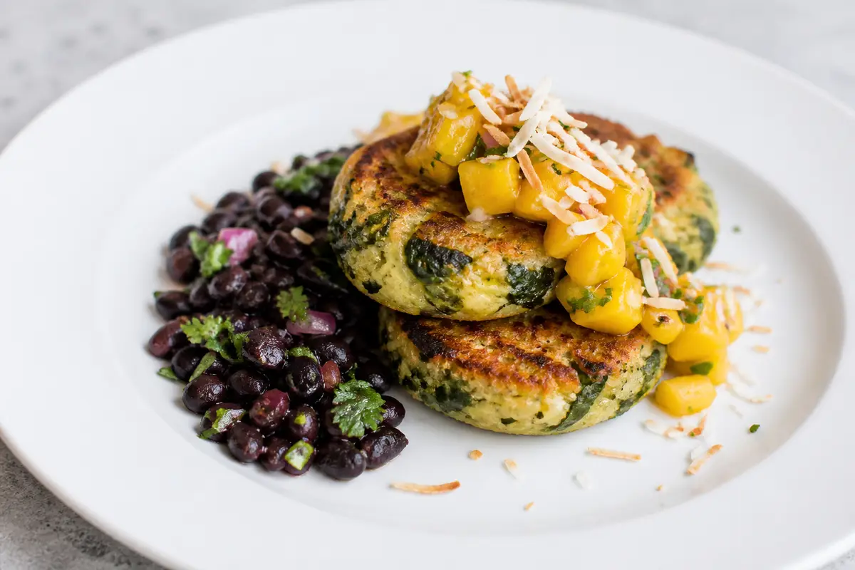 Cassava and Spinach Cakes with Spiced Black Beans, Mango Mojo and Toasted Coconut
