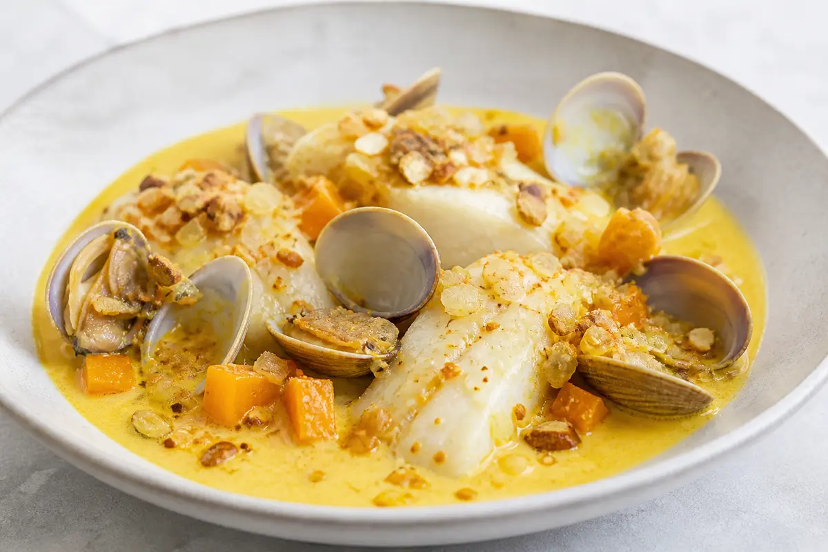 Hake and Clam Skillet with Saffron Pumpkin Cream and Crunchy Almond Crumbs